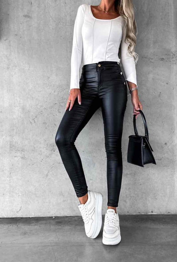Women's high-waisted skinny cut faux leather pants with gold buttons